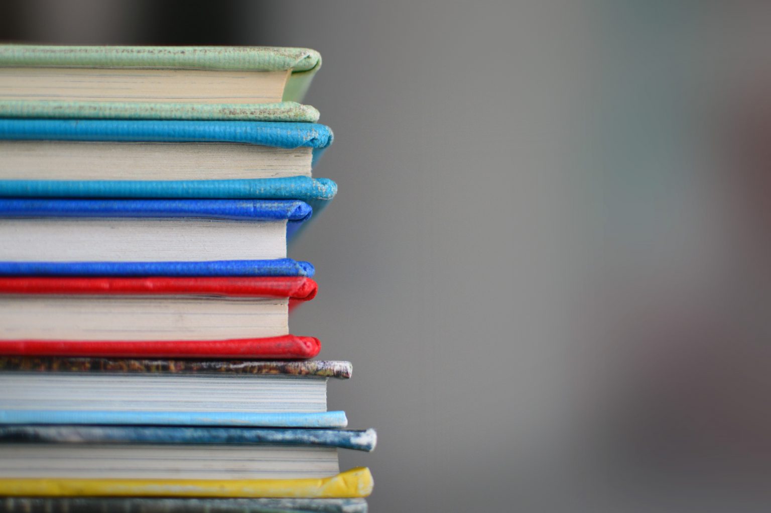 kimberly-farmer-lUaaKCUANVI-unsplash Stack of Books